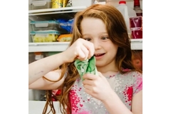 Girl opens an apple beverage by Brainiac Foods