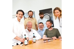 Image A team of employees with beer on the table.