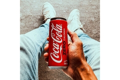 Image Man holding Coca-Cola beverage can.
