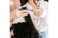 Image A woman cutting another woman's hair.