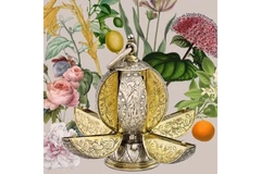 Image A fancy perfume bottle with flowers drawn behind it.