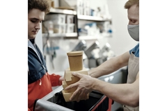Handing over takeaway food in packaging.