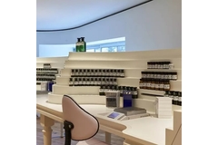 Image A seat at a fragrance manufacturing table and perfume bottles around.