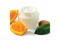 Image Tub of cream next to orange slice