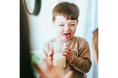 Image Young boy drinking milk.