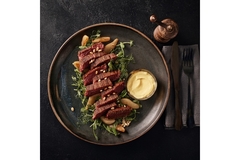 Image Plant-based steak on restaurant plate.