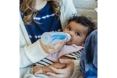 An infant drinking milk.