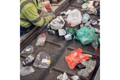 Sorting packaging waste on conveyor belt.