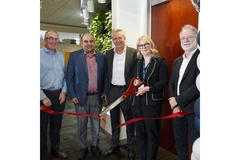Image Men and women cutting the ribbon.