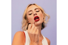 Woman applies purple lip loss