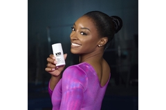 Image Simon Biles smiles carrying K18 product