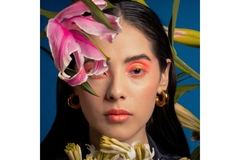 woman wearing makeup next to flower