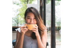 Image An Asian girl drinking coffee.