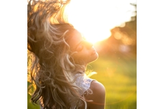 Image woman flips hair with sunset
