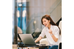 Image Woman fist pumps after scoring a deal