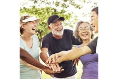 Image Group of seniors putting their hands together after exercising.