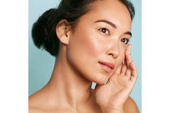 Image Woman with clear skin touches cheek