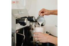 Pourring milk into cup.