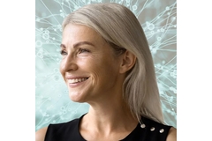 An older woman looking off to the side and smiling.
