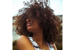 A woman with her hair flying in front of her face.