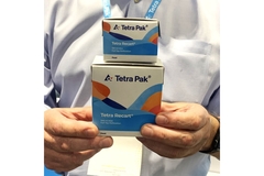 Image Man holding Tetra Recart boxes.