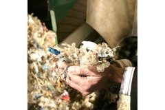 Image Man holding to-be-recycled plastics.
