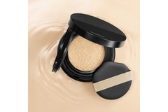 Image Maquillage cushion foundation in a pool of liquid foundation.