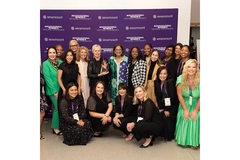 Image A group of women standing together and smiling who work for ELC.