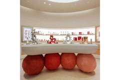Image four balls holding a platform up as a table on top of which are products