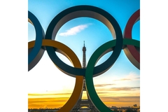 Image The Eiffel tower behind the Olympic rings as the sun rises over Paris.