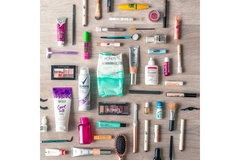 Image A collection of beauty products lying on the floor.