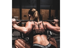 Image A woman works out at the gym.