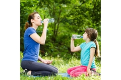 Mother and daughter drinking water.
