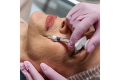Image An older woman getting injections in her face.