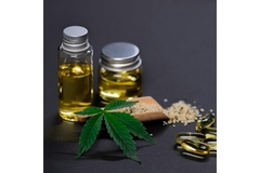 Image Bottle of CBD oil, cannabis leaves, hemp seeds and supplements.