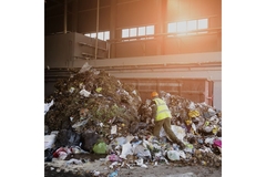 Image Worker sorting waste in facility.