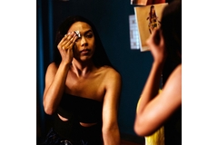 Image A woman wiping her makeup off with a wipe.