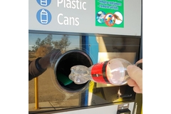 Image Returning empty plastic bottles.
