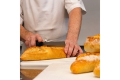 Image hands cutting bread.