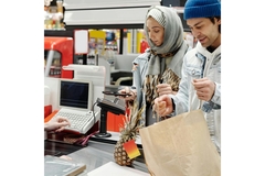 Man and woman paying for their food at a supermarket.