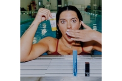 Image Anastasia Pagonis in the pool holding ELF products.