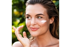 Image Woman with wet hair and dot of white cream on her cheeks