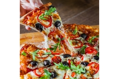 Image a hand picking up a pizza slice.