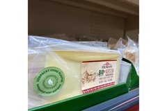 Image A package of cheese on a shelf.
