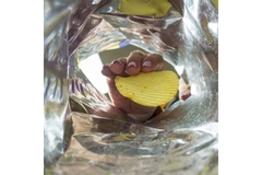 Hand in chips packaging.