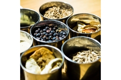 Image Several botanicals in tins on a table.