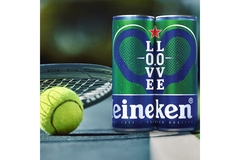 Image Two cans of beer are next to a tennis ball and a racket.