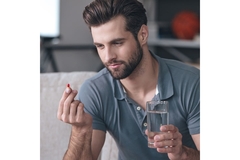 Image Man taking a pill