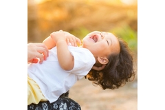 baby laughing on lap