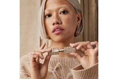 Image A woman holding a Spike Valentino Buttery Matte Lipstick.
